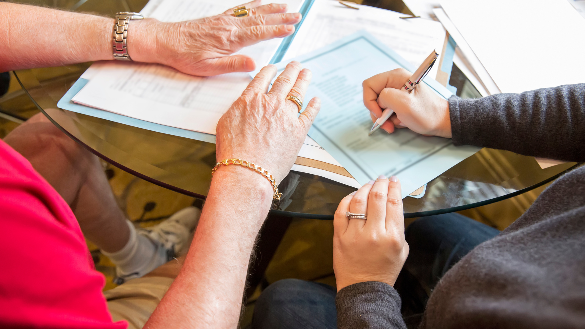 Elderly couple signing paperwork