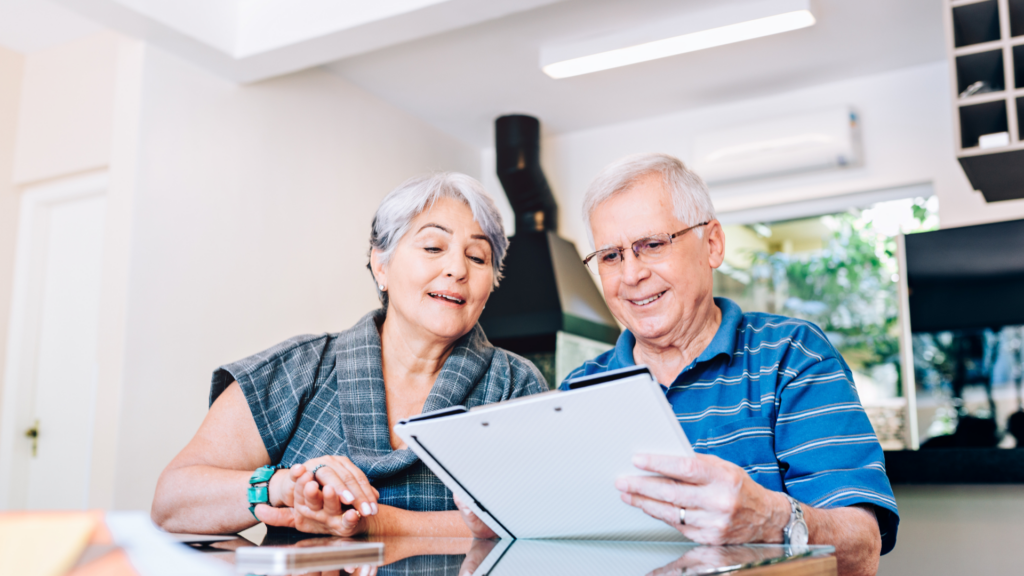 older couple sitting at table planning bills